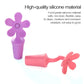Purple and pink/red flower-shaped silicone bottle stoppers, two pieces shown