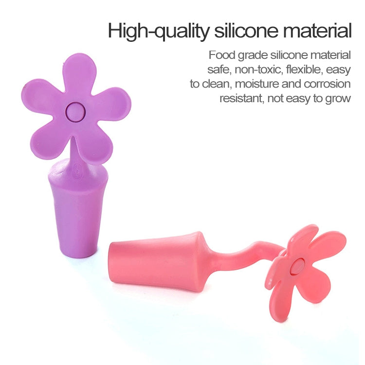 Purple and pink/red flower-shaped silicone bottle stoppers, two pieces shown