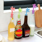 Colorful flower-shaped silicone bottle stoppers on wine bottles in a row