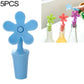 Blue flower-shaped silicone bottle stopper with round seal opening on a stem
