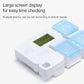 White electronic medication reminder box with sky blue lid and large green LCD screen