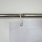 White shower curtain header with metal grommet for hanging on a rod
