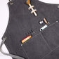 Dark grey thick canvas apron close-up with front pockets and small tool compartments