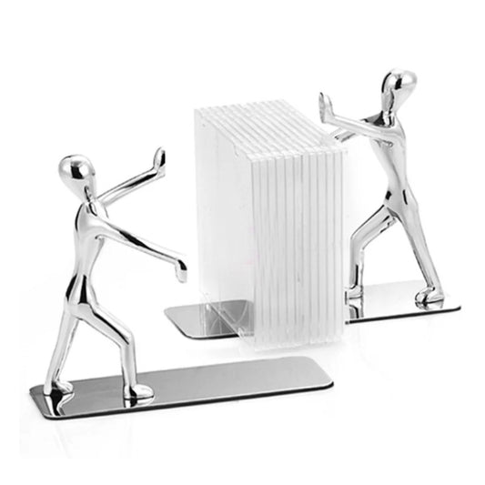Metal book push plate with standing figure sculpture beside book holder block, silver