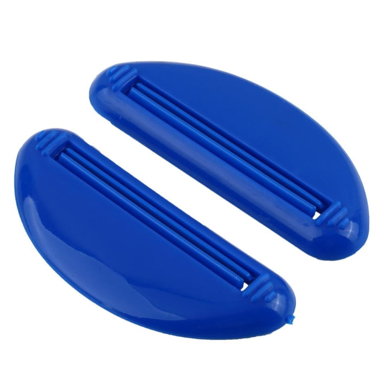 Pair of blue toothpaste squeeze tools, oval bodies with ridged internal press