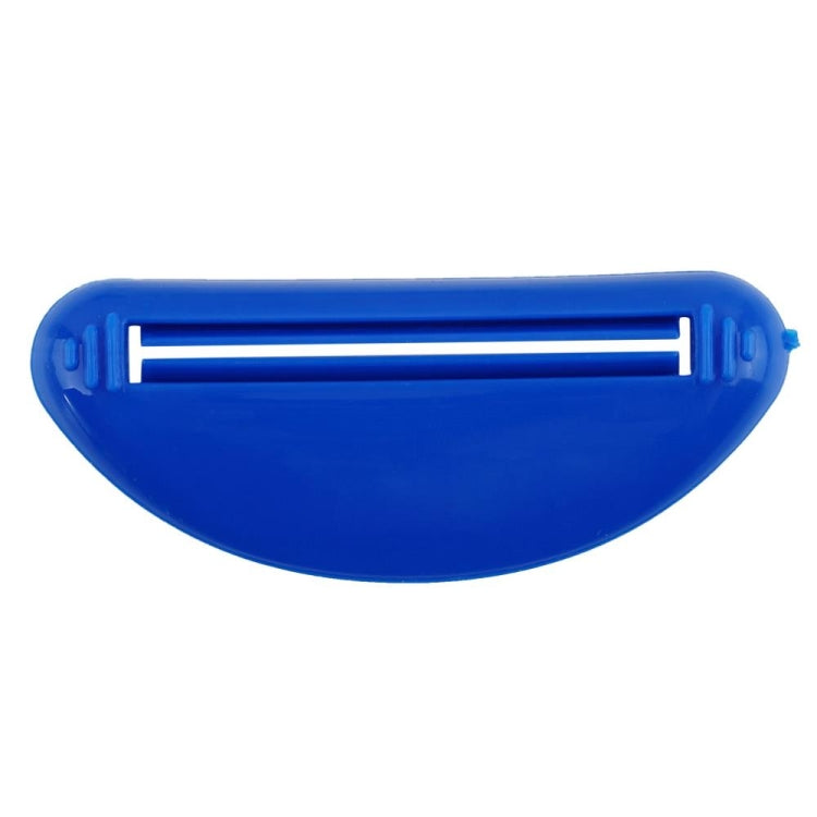 Blue toothpaste squeeze tool close-up, oval case with inner bar for pressing