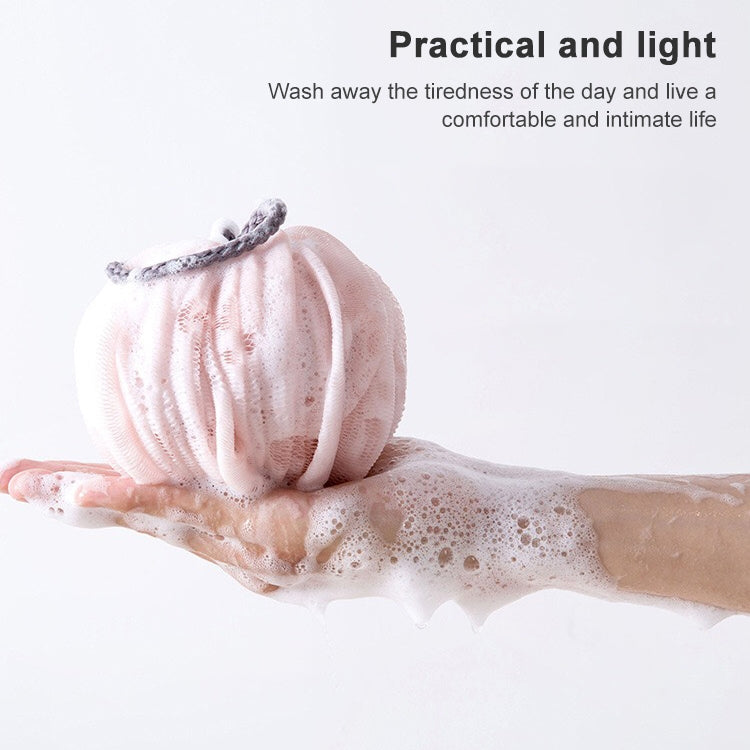 Pink mesh bath sponge lantern with foam lather on hand
