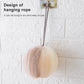 Beige mesh bath sponge lantern hanging on a rope