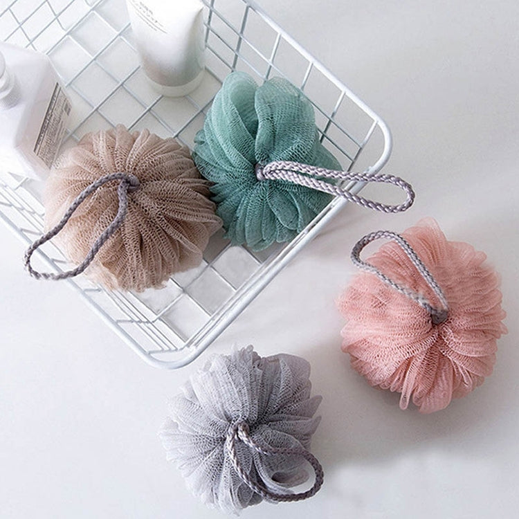 Assorted color mesh bath sponge lanterns on a wire tray
