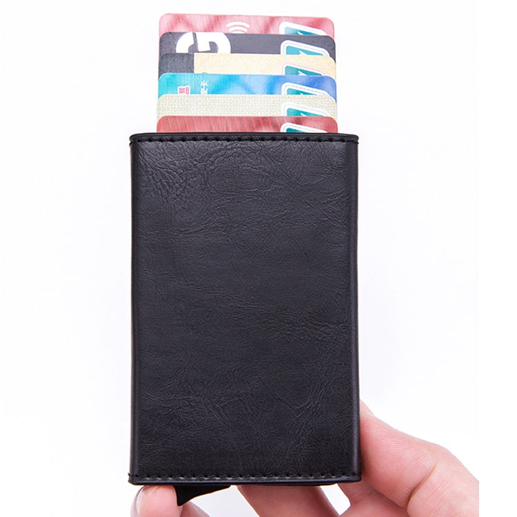 RFID card wallet, black faux leather, upright front view held in hand
