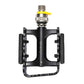 Black single bike pedal with yellow quick-release lever, silver axle, and orange reflectors
