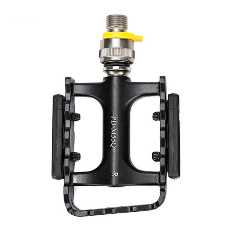 Black single bike pedal with yellow quick-release lever, silver axle, and orange reflectors