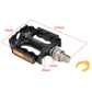 Black bike pedal with orange reflector strip, silver quick-release axle, and open cage