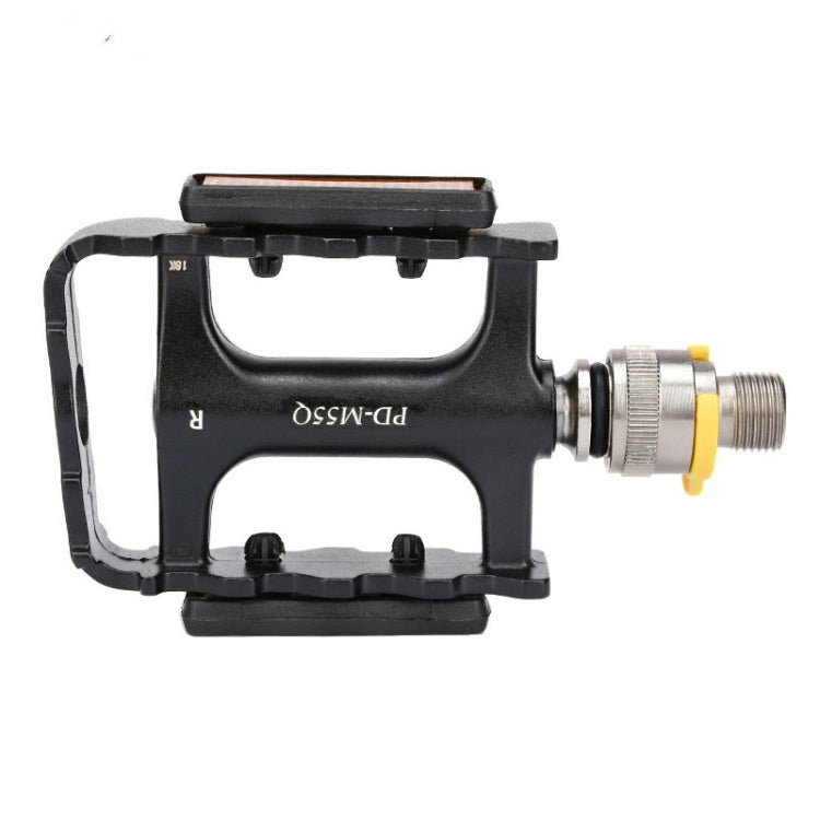 Black bike pedal with orange reflector strip and silver threaded axle