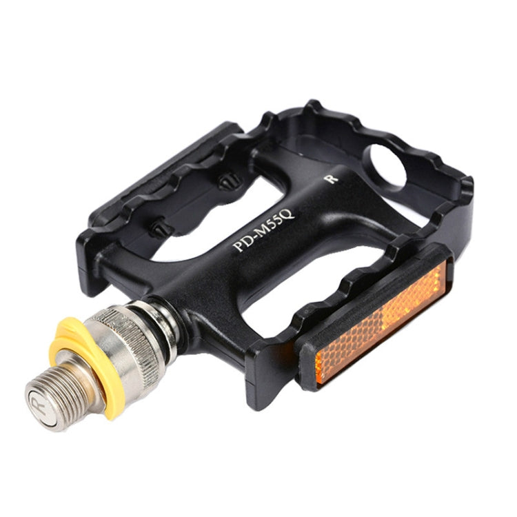 Black bike pedal with orange reflector, silver axle, and R marking on the cage