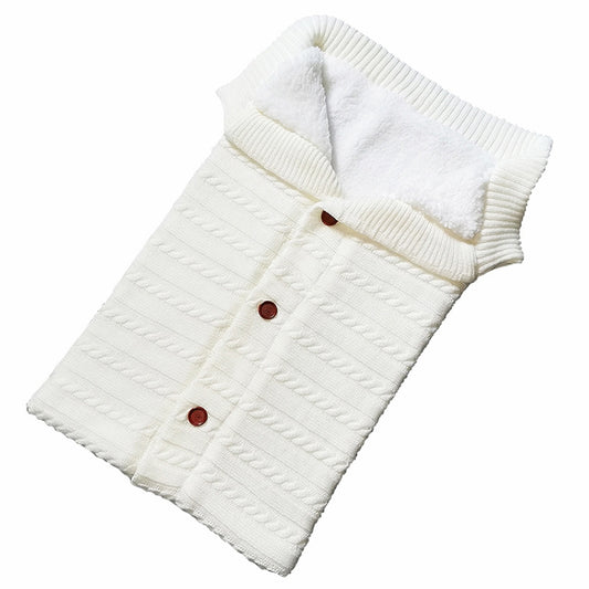 Newborn knitted cotton sleeping bag in white with envelope flap and snap buttons