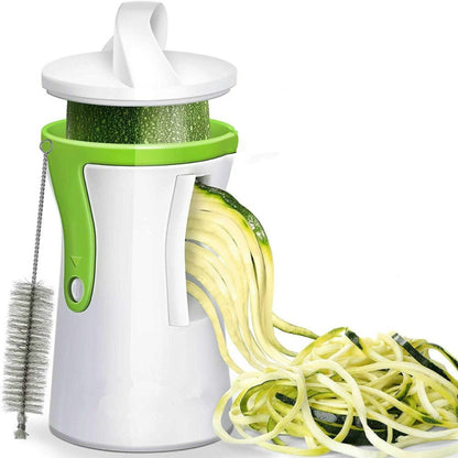 White and green rotating spiral vegetable grater with lid and brush for cleaning.