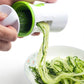 Hands feeding cucumber into a green spiral grater, shredded strands falling out.