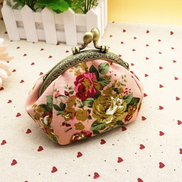 Pink floral small kiss-lock wallet with gold-tone clasp frame and round clasp