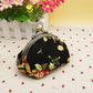 Black floral small kiss-lock wallet with gold-tone clasp and rounded metal frame