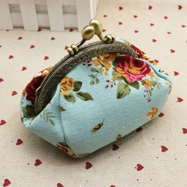 Light blue floral small kiss-lock wallet with gold-tone clasp and rounded frame