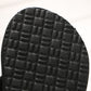 Textured tread pattern on the bottom of a black wedge flip-flop sole