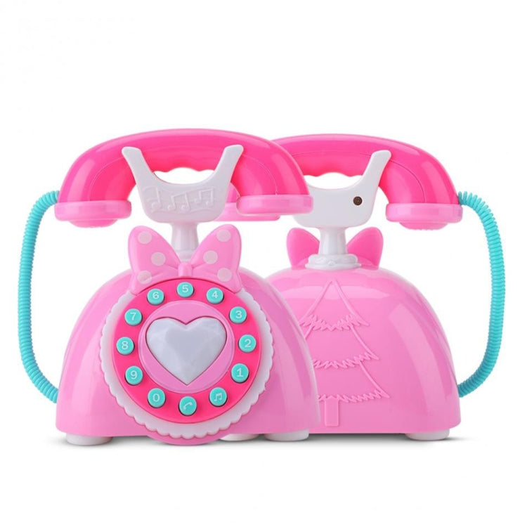 Pink retro musical telephone toy with heart dial, butterfly headband, and handset detail