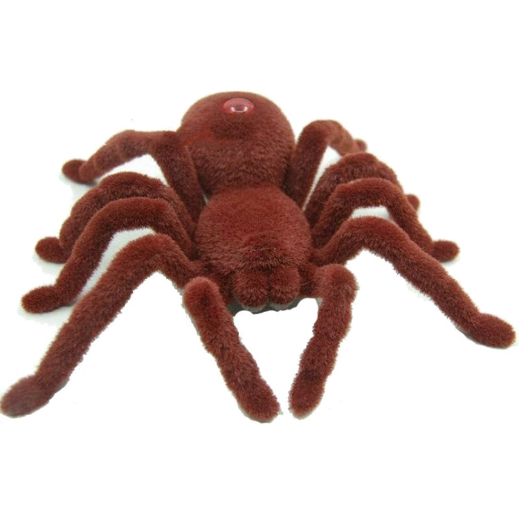 Brown plush remote-control spider toy with red glowing eye and long fuzzy legs