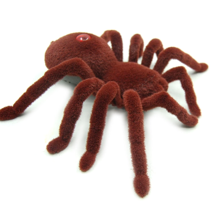 Brown plush remote-control spider toy side view with red eye and raised fuzzy legs
