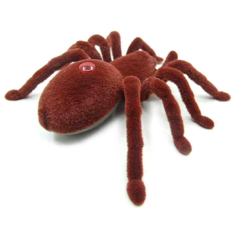 Brown plush remote-control spider toy with red eye and curled fuzzy body, legs down