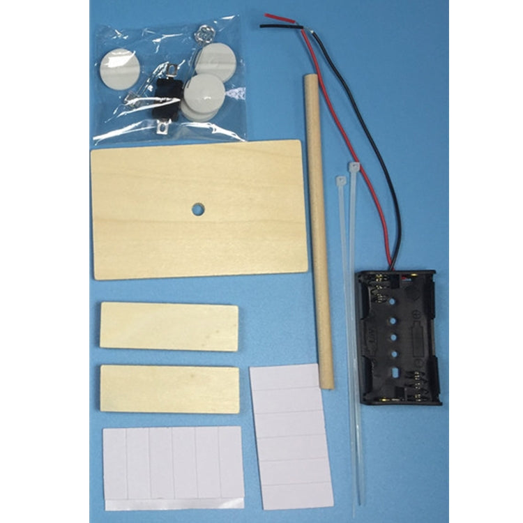 DIY table lamp kit parts: wooden base pieces, battery holder, and circuit components