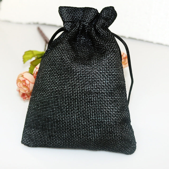 Black linen drawstring gift bag with gathered top and black rope tie.