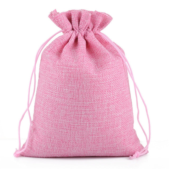 Pink linen drawstring gift bag with gathered top and pink rope drawstring.