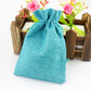 Linen jute drawstring gift bag in turquoise blue, gathered top with long cords