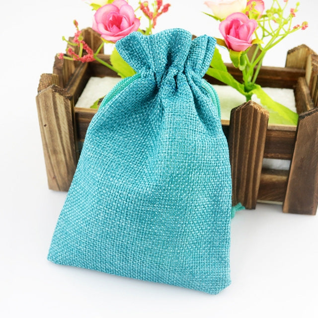Linen jute drawstring gift bag in turquoise blue, gathered top with long cords