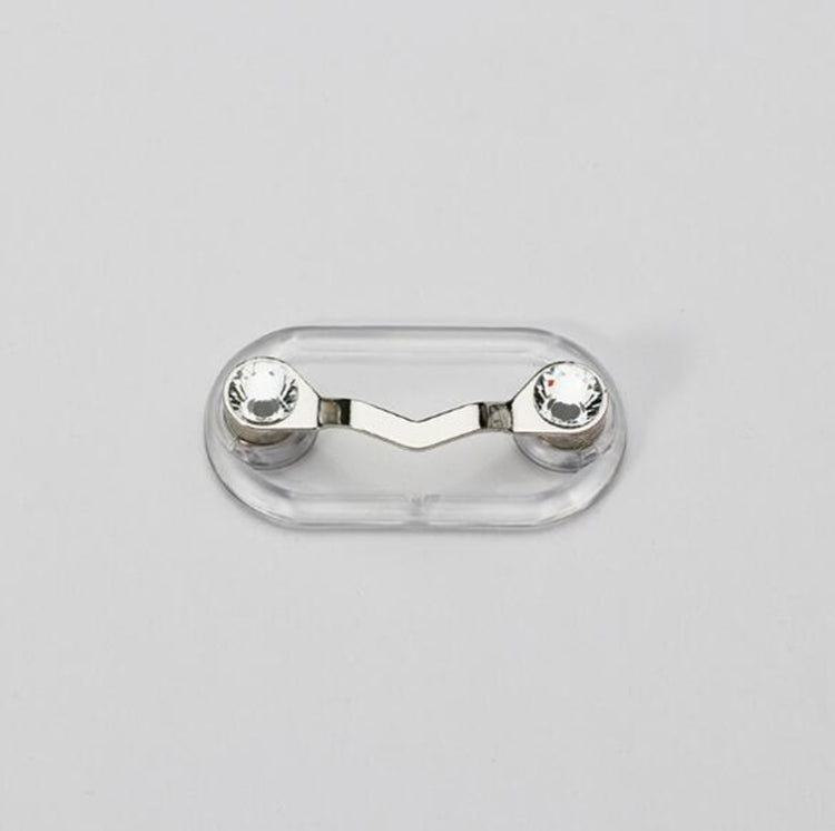 Clear oval magnetic glasses holder with silver end caps and decorative details