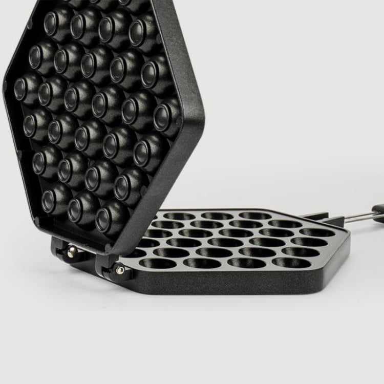 Open non-stick egg puff mold tray with round cavities on hinged pan