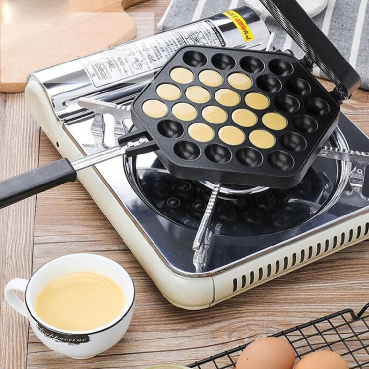 Non-stick egg puff maker on a countertop grill base with empty cavity wells