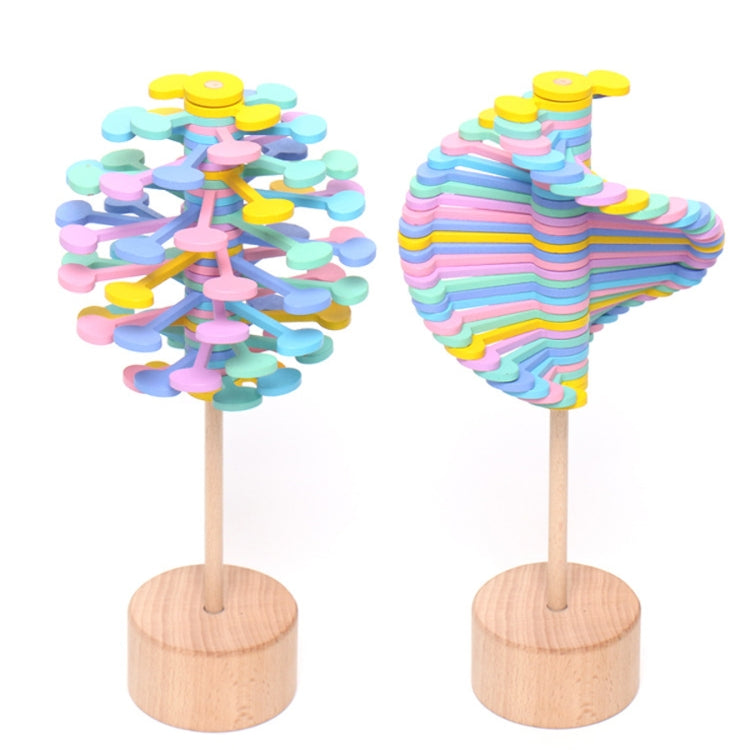 Pastel stacked-disc lollipop and rainbow striped heart lollipop on round wooden bases