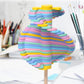 Rainbow striped stacked-disc lollipop decompression toy on a round wooden base