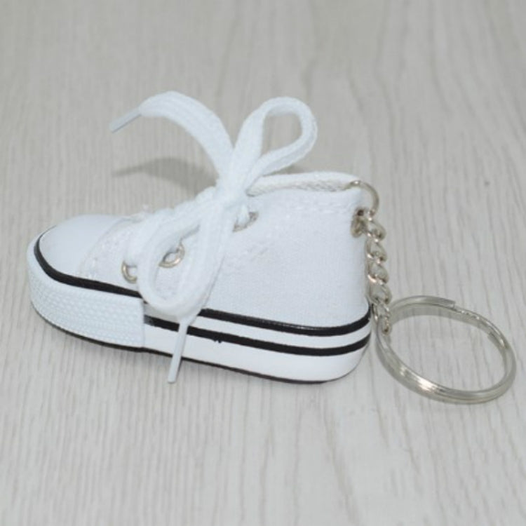 White mini canvas sneaker keychain, side view with metal chain and key ring