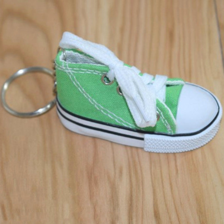 Green mini canvas sneaker keychain with white laces and metal key ring