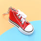 Red mini canvas sneaker keychain with white laces and metal key ring