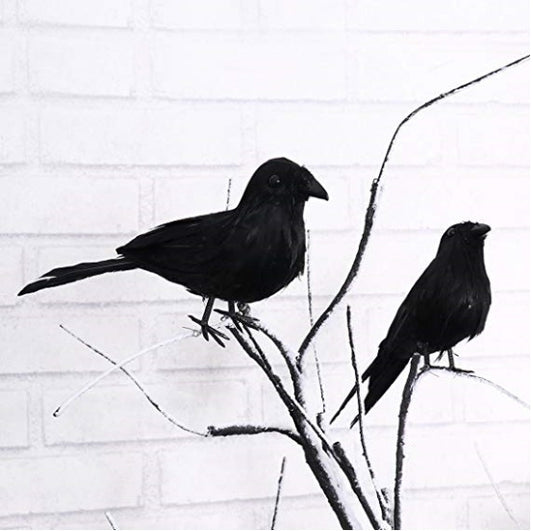 Set of black simulated crow decorations perched on twig branches with slender feet.