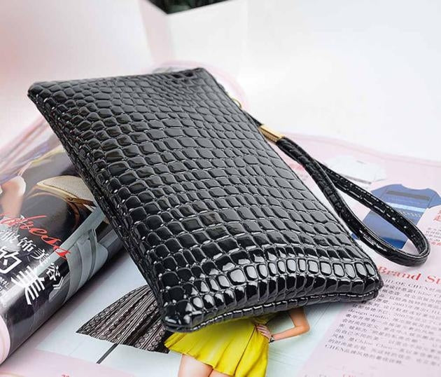 Black crocodile-pattern ladies clutch wallet with wrist strap, open top view