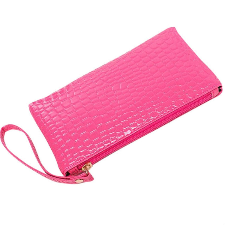 Pink crocodile-pattern ladies clutch wallet with wrist strap and zip closure