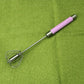 Egg beater whisk with stainless wire beaters and pink handle
