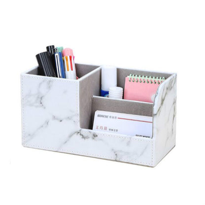 Marble-pattern multi-compartment pen holder with notebook and pen slots, white.