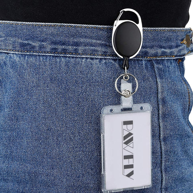 Clear vertical ID badge holder clipped to a belt loop with a black retractable cord and tag