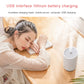 Gray mini humidifier on a table, USB charging-ready portable device with top vent.